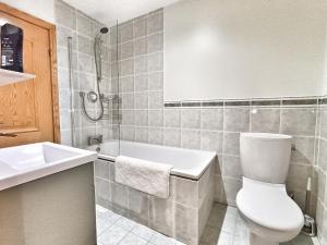 a bathroom with a toilet and a tub and a sink at Golf View, Cruden Bay in Cruden Bay +19 photos