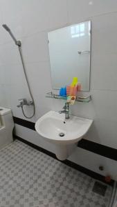 a bathroom with a white sink and a mirror at Hotel Hương Phong in Binh Chau +11 photos