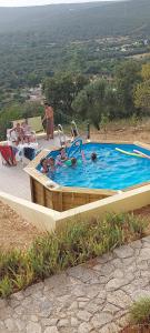 a group of people in a swimming pool at Casa do Castelão in Loulé