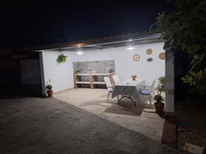 a patio with a table and chairs in a garage at Chalet casa la adelfa in Chiclana de la Frontera
