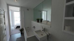 a white bathroom with a sink and a mirror at Nirankaar peace 1bhk in Birmingham +25 photos