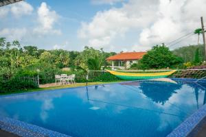a house with a swimming pool with a boat on it at Monara Villa in Dharga Town