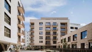 a rendering of an apartment complex with buildings at Studio 202 in Brno