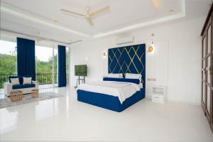 a bedroom with a king sized bed and a chair at Monara Villa in Dharga Town +31 photos