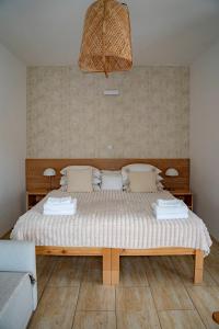 a bedroom with a large bed with white sheets at Cudne Manowce in Wisła
