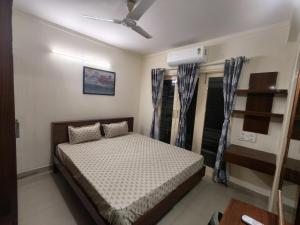 a bedroom with a bed and a ceiling fan at 2bhk furnished Richmond town in Bangalore