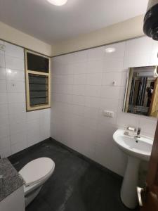 a bathroom with a toilet and a sink at 2bhk furnished Richmond town in Bangalore +9 photos