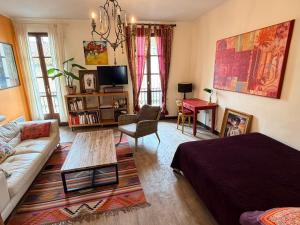 a living room with a couch and a table at La Vigneronne in Maureilhan-et-Raméjan