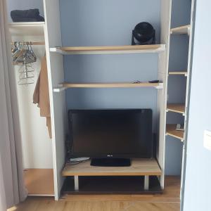 a tv sitting on a shelf in a closet at Casanova home in Saint-Denis