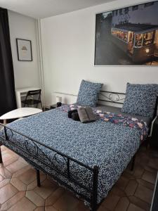 a bedroom with a bed with a blue comforter at Casanova home in Saint-Denis