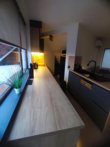 a kitchen with a wooden counter top in a room at Апартамент Skyline in Yambol