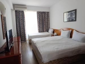a hotel room with two beds and a window at Hotel Tourist - Metropol Lake Resort in Ohrid