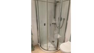 a shower stall with a toilet in a bathroom at Apartment Ostseeblick 131 in Timmendorfer Strand