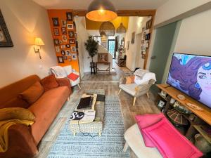 a living room with a couch and a table at La Vigneronne in Maureilhan-et-Raméjan +7 photos