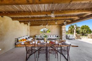 an outdoor dining room with a table and chairs at Masseria Marchese by Perle di Puglia in Montesano Salentino