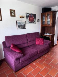 a purple couch sitting in a living room at Maison Gerbore in La Salle