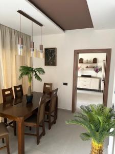 a dining room with a table and chairs and a bedroom at VILLA Noor Atlas in Aghmat
