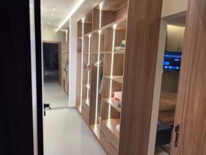 a walk in closet with wooden cabinets and a door at VILLA Noor Atlas in Aghmat