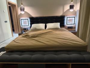 a large bed in a bedroom with two pillows at VILLA Noor Atlas in Aghmat
