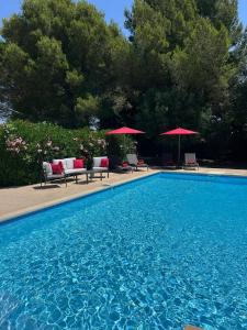 a large swimming pool with chairs and umbrellas at The yurt at Gites 474 in Sallèles-dʼAude +5 photos