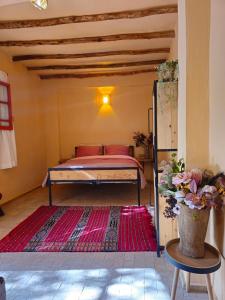 a bedroom with a bed in a room with a rug at Dar Zaytoun Bhalil in Bhalil +130 photos