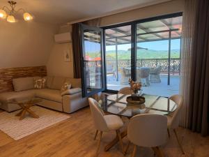 a living room with a glass table and chairs at Limani Vasiliko in Tsarevo