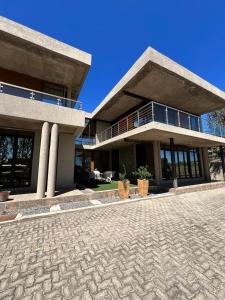 a house with a brick driveway in front of it at Mosia Guest House in Maseru