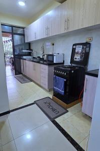 a kitchen with a stove top oven in a room at The African Artisan 3BR Apartment in Nairobi