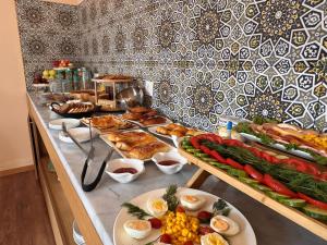 a buffet with many different types of food on a table at Sunrise Apartments in Dushanbe +24 photos