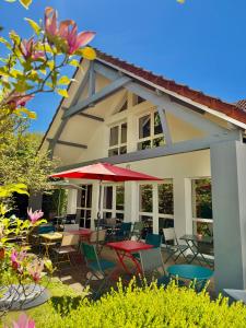 a patio with tables and chairs in front of a house at Sure Hotel by Best Western Limoges Sud in Feytiat