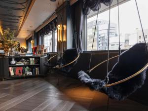 a room with two chairs and a window at Mercure Tokyo Hibiya in Tokyo
