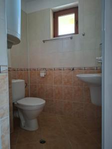 a bathroom with a toilet and a sink at Ivet Guest Rooms - Obzor in Obzor
