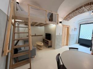 a room with a table and a bunk bed at Encanto Griego in Chios