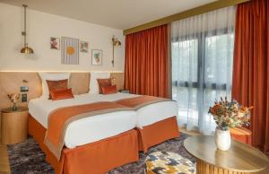 a hotel room with a bed and a large window at Hôtel Burdigala by Inwood Hotels in Bordeaux +55 photos