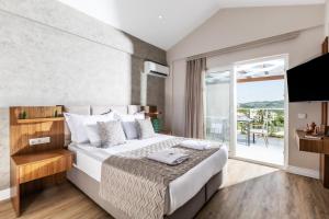 a bedroom with a large bed and a balcony at Unique Residence Hotel Golf and Spa in Soke +77 photos