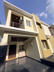 a house with a garage in front of it at Veechi Retreat in Secunderabad