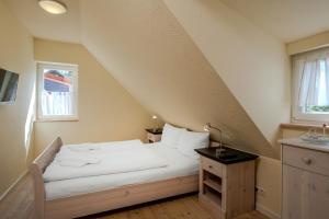 a bedroom with a bed and a window at Heideröschen Park Heideröschen 5c in Zingst