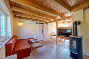 a living room with a red couch and a wood stove at Heideröschen Park Heideröschen 5c in Zingst