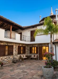 a house with a patio and a palm tree at Santo Re Olive Retreat in Petrizzi
