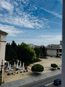 a view of a courtyard with a fountain and chairs at Ultracentral style apartment! in Craiova