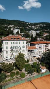 an aerial view of a building with a tennis court at Hotel Lovran in Lovran