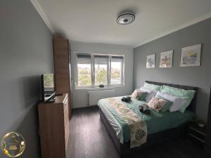 a bedroom with a bed and a television in it at Ural Home in Székesfehérvár