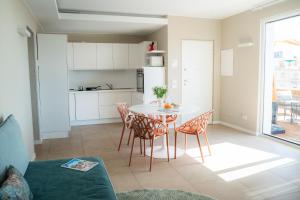 a kitchen and dining room with a table and chairs at Residence San Marco Suites&Apartments Alassio in Alassio