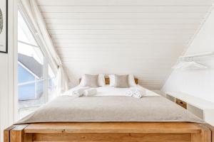 a bed in a room with a large window at Schiller in Wandlitz