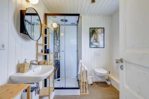 a bathroom with a sink and a toilet and a mirror at Schiller in Wandlitz +31 photos