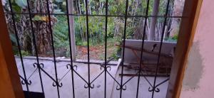 an iron gate with a bench in front of a window at CasaLima in Bragança