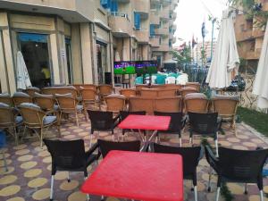 a group of tables and chairs in front of a building at Bianco Matrouh Hotel in Marsa Matruh
