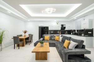a living room with a couch and a table at Eagle's Nest - Adjoining Villas! in Tsilivi