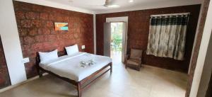 a bedroom with a bed and a red wall at Hotel Casa viora at swimming pool in Calangute