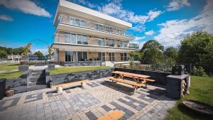 a house with a picnic table in front of it at Apartamenty Na wzgórzu in Ińsko